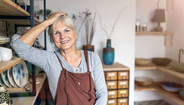 female entrepreneur wearing apron in retail shop