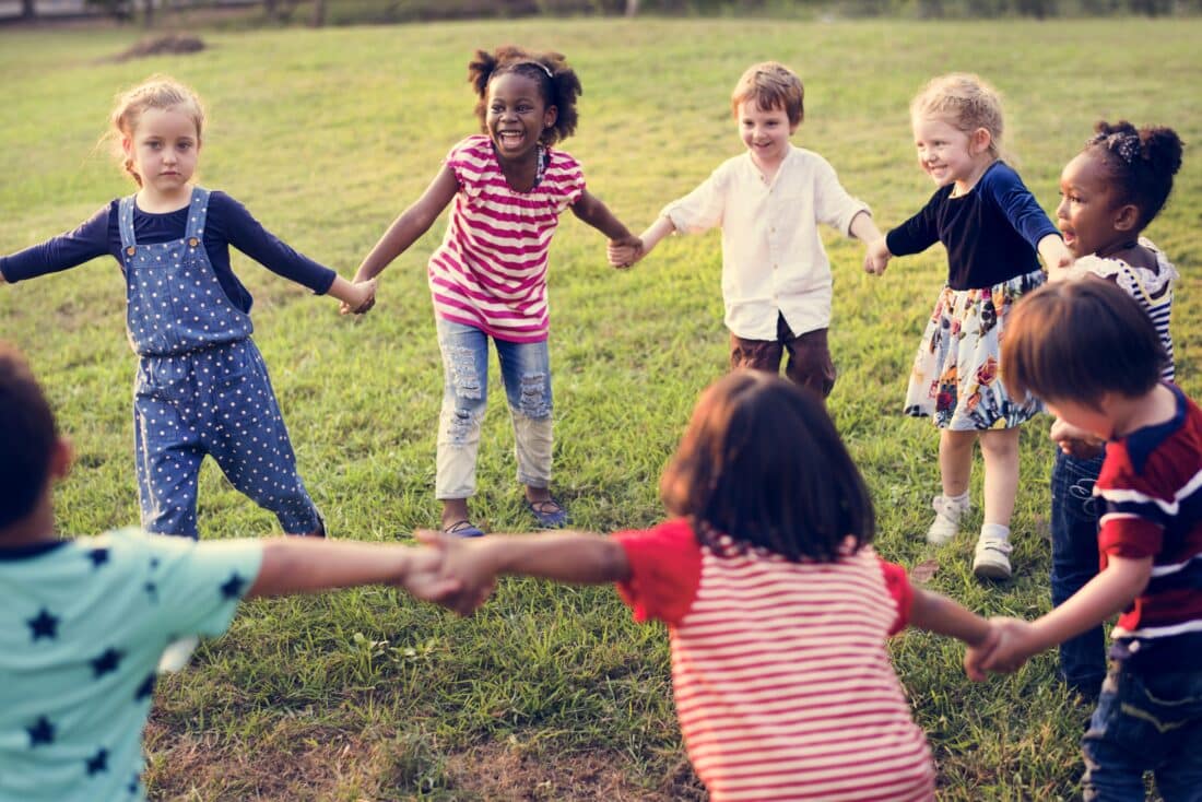 diverse group of kids playing in a circle