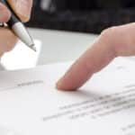 Business owner signing a nondisclosure agreement to protect confidential information.