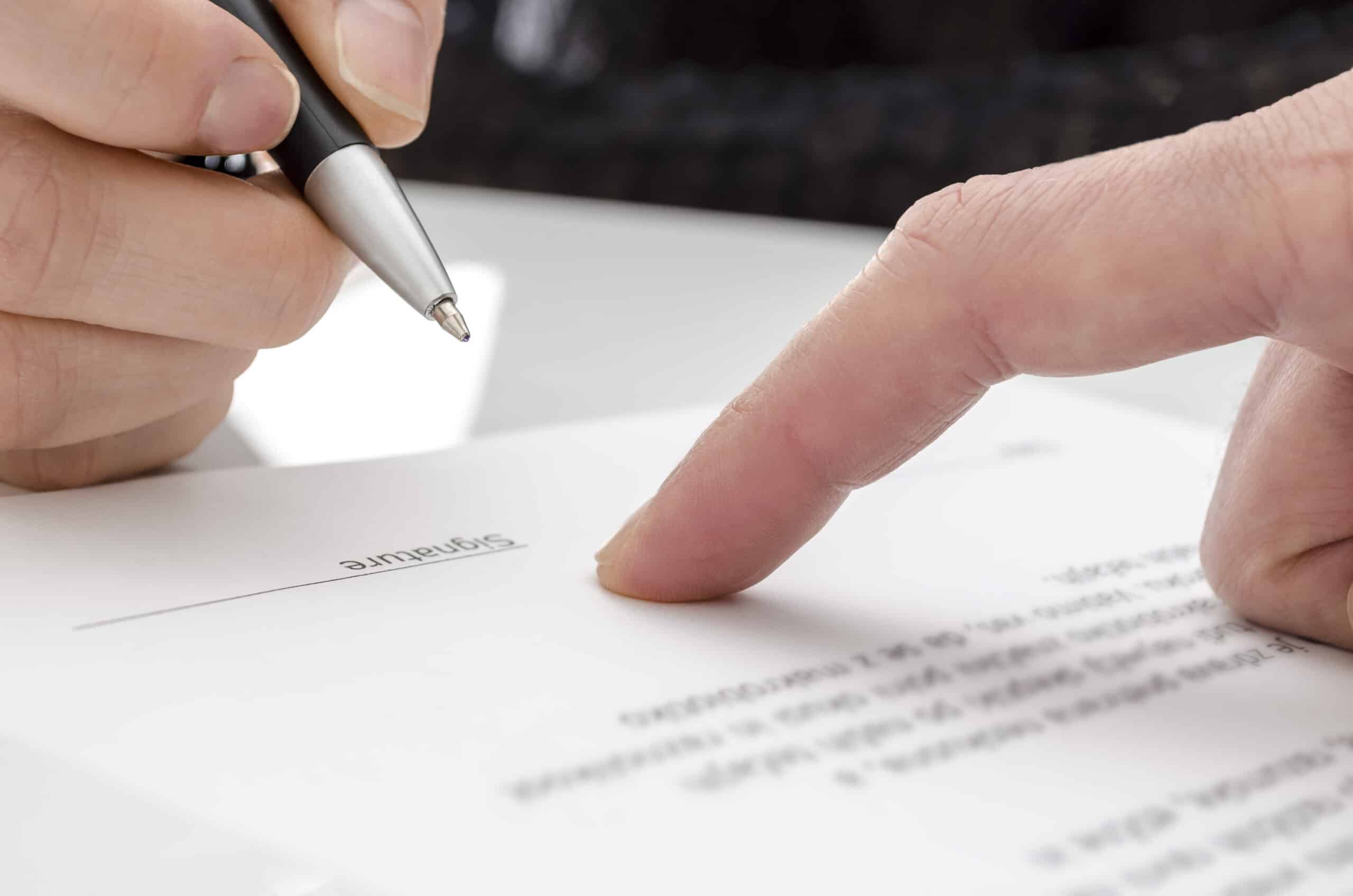 Business owner signing a nondisclosure agreement to protect confidential information.